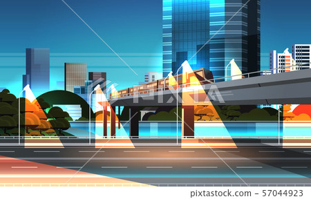 highway road night city street with modern skyscrapers train on railway monorail crossing bridge 57044923