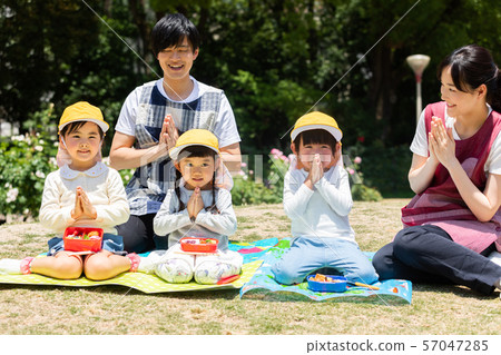 Children eating lunch in the park Children eating lunch in the park 57047285