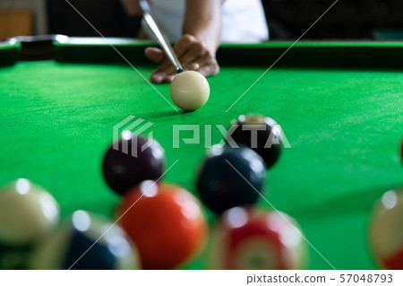 Man's hand and Cue arm playing snooker game or 57048793