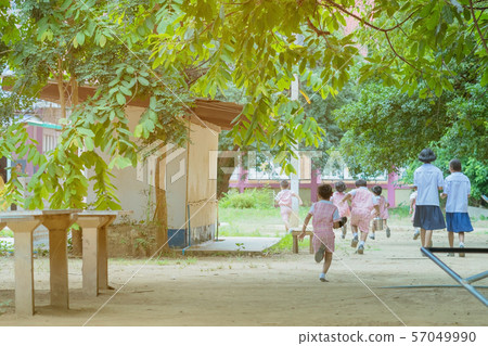 Back view of Kindergarten students run back to the classroom after having lunch. Back view of Kindergarten students run back to the classroom after having lunch. 57049990