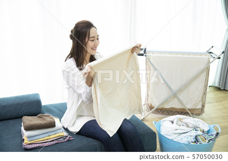 woman folding laundry 57050030