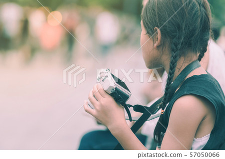 Asian girl learning to use a mirrorless camera 57050066