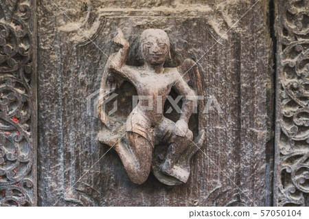 Archaeological, Close Up of carved art figures on old wood carvings on the wall temple at Shwe Nan Daw Kyaung (Golden Palace Monastery) in Mandalay, Myanmar Archaeological, Close Up of carved art figures on old wood carvings on the wall temple at Shwe Nan Daw Kyaung (Golden Palace Monastery) in Mandalay, Myanmar 57050104