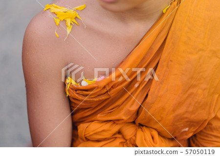 People pouring water to Buddhist Monk and gives blessing in Thailand Songkran annual festival in Buddhist temple. People pouring water to Buddhist Monk and gives blessing in Thailand Songkran annual festival in Buddhist temple. 57050119