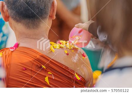 People pouring water to Buddhist Monk and gives blessing in Thailand Songkran annual festival in Buddhist temple. People pouring water to Buddhist Monk and gives blessing in Thailand Songkran annual festival in Buddhist temple. 57050122