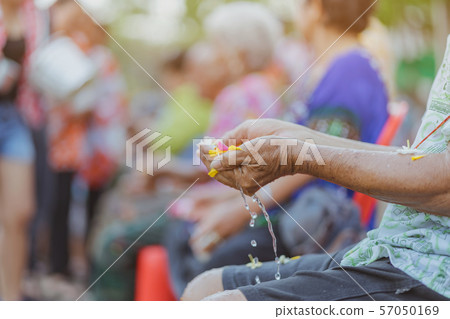Thai people celebrate Songkran by pouring water and giving garlands to elder senior or respected grandparents and elder and asked for blessings for celebrate Songkran in new year water festival Thai people celebrate Songkran by pouring water and giving garlands to elder senior or respected grandparents and elder and asked for blessings for celebrate Songkran in new year water festival 57050169