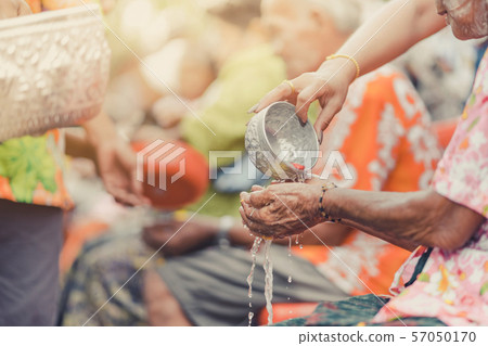 Thai people celebrate Songkran by pouring water and giving garlands to elder senior or respected grandparents and elder and asked for blessings for celebrate Songkran in new year water festival Thai people celebrate Songkran by pouring water and giving garlands to elder senior or respected grandparents and elder and asked for blessings for celebrate Songkran in new year water festival 57050170