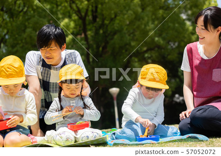 Children eating lunch in the park Children eating lunch in the park 57052072