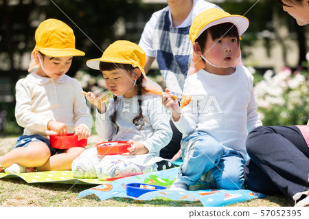 Children eating lunch in the park Children eating lunch in the park 57052395
