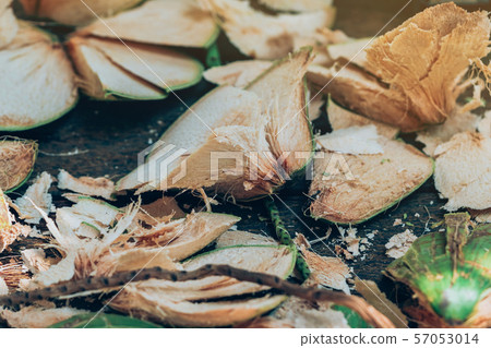 Close up to Coconut peel on the table after being peeled to make coconut juice. Close up to Coconut peel on the table after being peeled to make coconut juice. 57053014