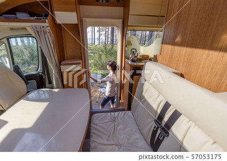 Woman in the interior of a camper RV motorhome Woman in the interior of a camper RV motorhome 57053175