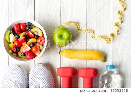 Healthy lifestyle for women diet with dumbbells  57053356