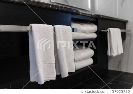 Close up of luxury bathroom towels in a monochrome ensuite Close up of luxury bathroom towels in a monochrome ensuite 57055750