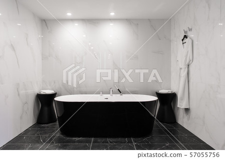 Freestanding black bathtub, stylish minimalist black and white loft style bathroom. Bath, washstand 57055756
