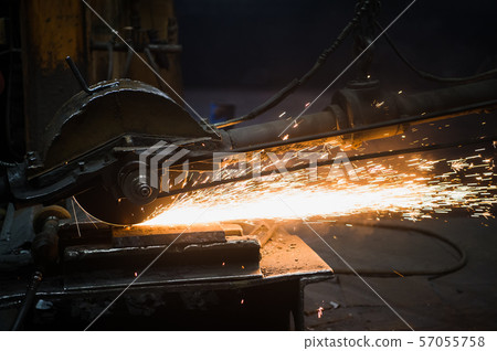 Sparks from circular saw at steel factory. Metal sawing close up. Sparks from circular saw at steel factory. Metal sawing close up. 57055758