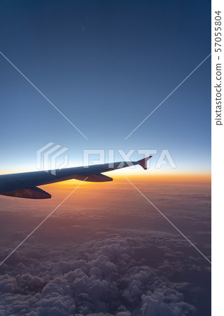 view of aircraft wing silhouette and dark blue sky  57055804
