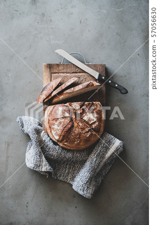 Freshly baked sourdough bread on wooden board Freshly baked sourdough bread on wooden board 57056630