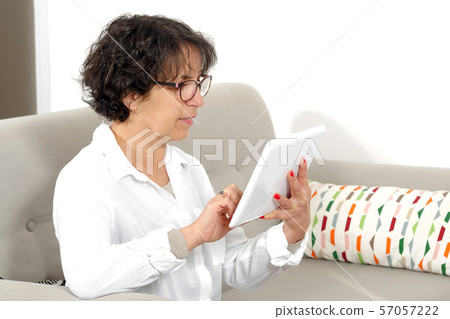 beautiful senior woman using a tablet beautiful senior woman using a tablet 57057222