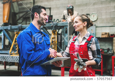 Worker in factory or workshop discussing project 57057567