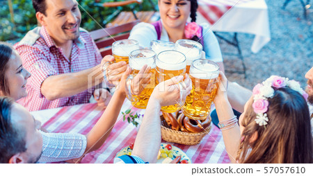 People enjoying food and drink in Bavarian beer garden 57057610