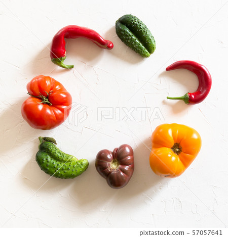 Ugly tomato, pepper, cucumber on white.  57057641