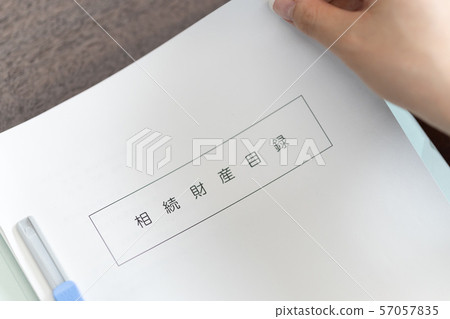 Tax accountant looking at inheritance list 57057835