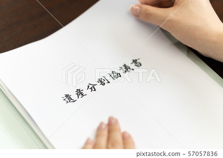 Tax accountant looking at heritage split agreement 57057836