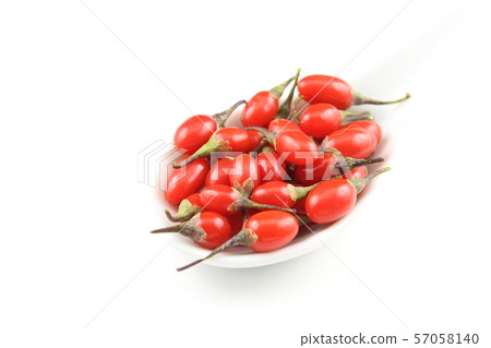 fresh goji berries in a white porcelain spoon 57058140