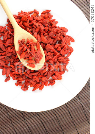 dried goji berries on a wooden spoon 57058245