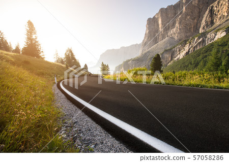 Asphalt road in Dolomites in a summer day. 57058286
