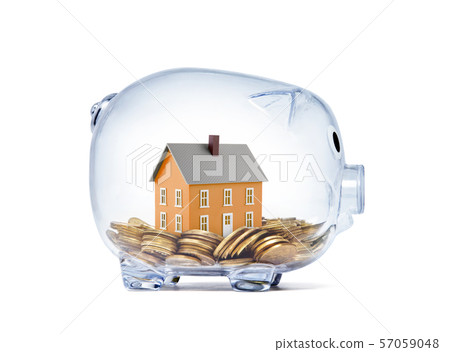 Orange house on money inside transparent piggy bank with clipping path  57059048