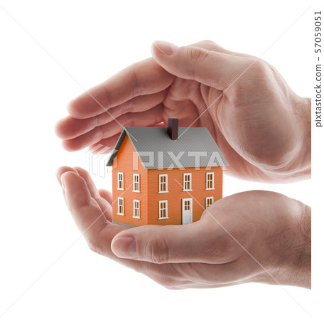 Small orange toy house protected by hands isolated on white  57059051