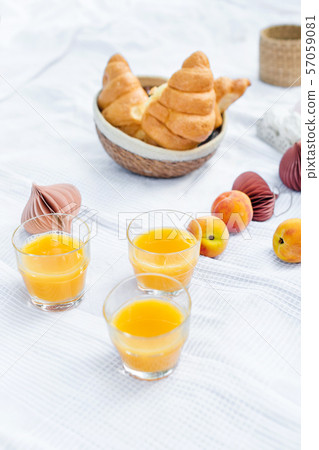 Healthy summer picnic laid out on white cloth on Healthy summer picnic laid out on white cloth on 57059081