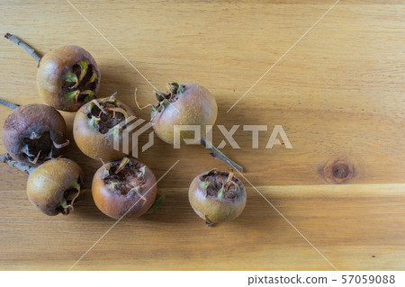 fresh medlar fruits on a wooden board 57059088