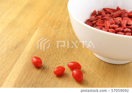 dried goji berries in a small white bowl dried goji berries in a small white bowl 57059092