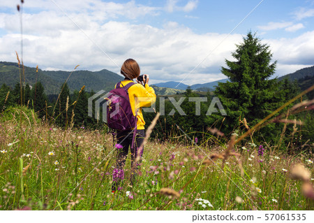 tourist girl standing at the meadow tourist girl standing at the meadow 57061535