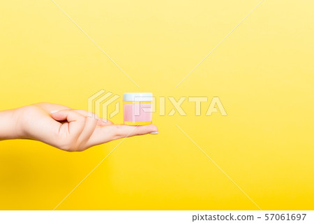 Female hand holding cream bottle of lotion Female hand holding cream bottle of lotion 57061697