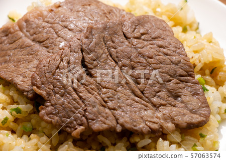 Up of yakiniku (domestic beef / shoulder loin) on top of fried rice. Up of yakiniku (domestic beef / shoulder loin) on top of fried rice. 57063574