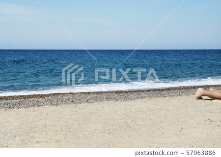 man lying down on the beach 57063886