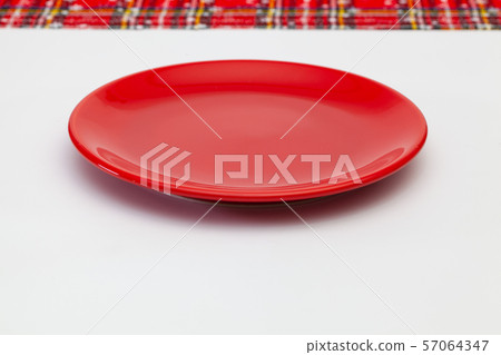 Red plate and Christmas decoration  57064347