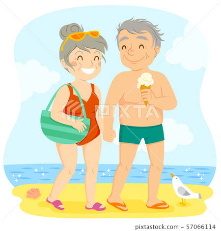Happy older couple in swimsuits holding hands and walking on the beach 57066114