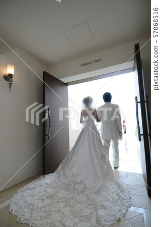 Bride and groom heading for the pastor at the wedding 57068516