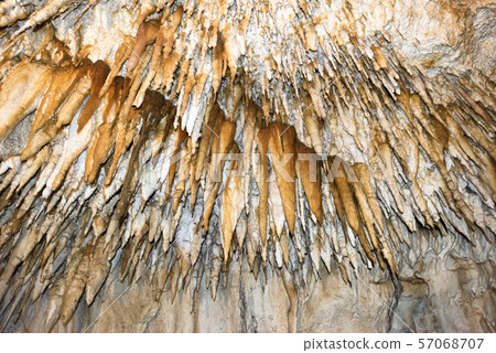 Ancient cave with stalactites and stalagmites Ancient cave with stalactites and stalagmites 57068707