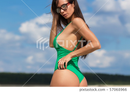 Slim lady in green swimming suit Slim lady in green swimming suit 57068966