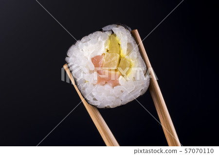 Close-up of sushi roll with salmon on black background 57070110