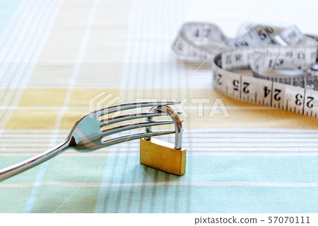 Metal fork locked with padlock and measuring tape 57070111