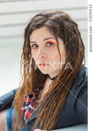 Beauty, style and fashion concept - Portrait of young beautiful woman with stylish makeup and 57070513