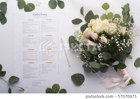 Bridal roses bouquet and planning checklist on white Bridal roses bouquet and planning checklist on white 57070975