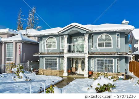 Big luxury family house on winter season with blue sky background. Big luxury family house on winter season with blue sky background. 57071230
