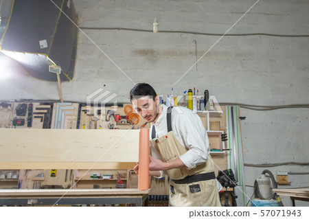 Small-Sized Companies, furniture and worker concept - Handsome young man working in the furniture Small-Sized Companies, furniture and worker concept - Handsome young man working in the furniture 57071943